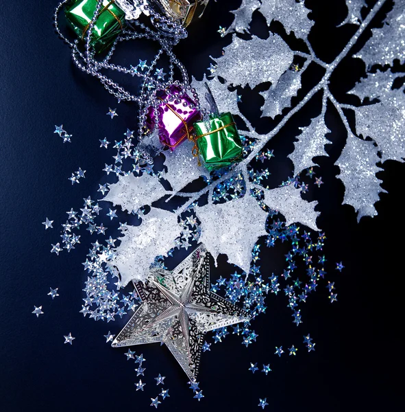 Stella d'argento, scatole regalo e foglie bianche gelide su nero — Foto Stock