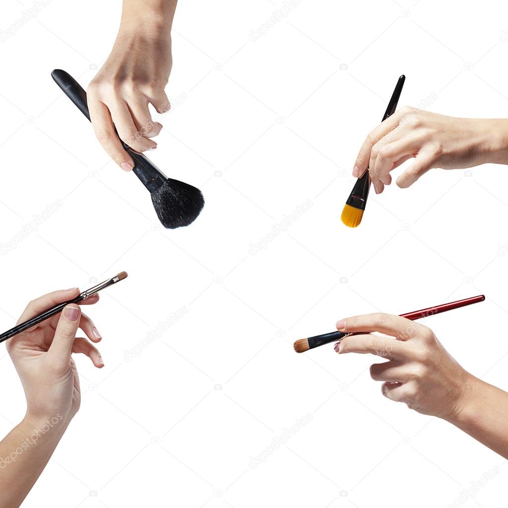 Isolated female hands with a brushes for makeup