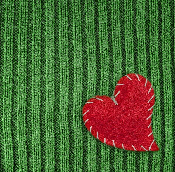 Heart on green knitted wool background — Stock Photo, Image