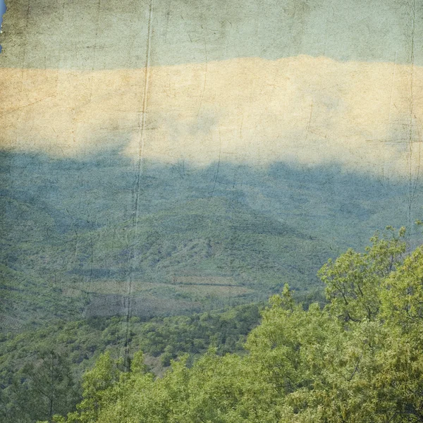 Textured old paper background with mountains — Stock Photo, Image