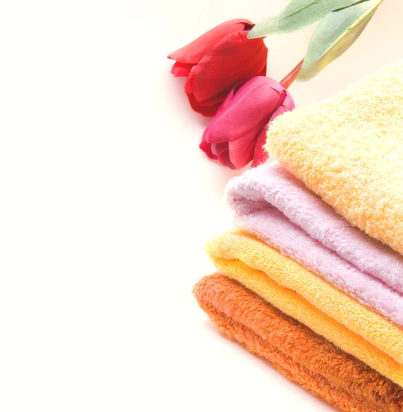 Stack of colorfull towels and tulips isolated — Stock Photo, Image