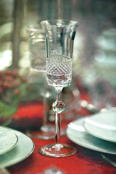 Glass and plate on tablecloth — Stock Photo, Image