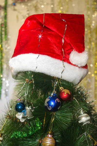 Red hat on a Christmas tree — Stock Photo, Image