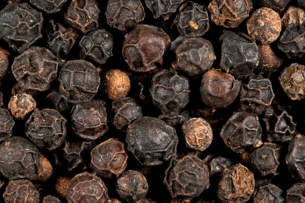 Black peppercorn background, macro — Stock Photo, Image