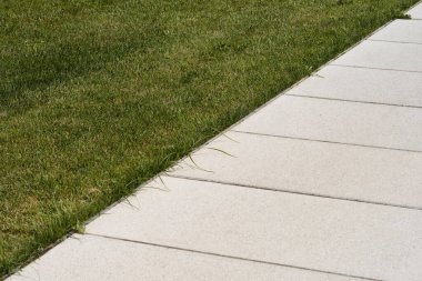 Detail of stone path and grass beside it - abstract wallpaper