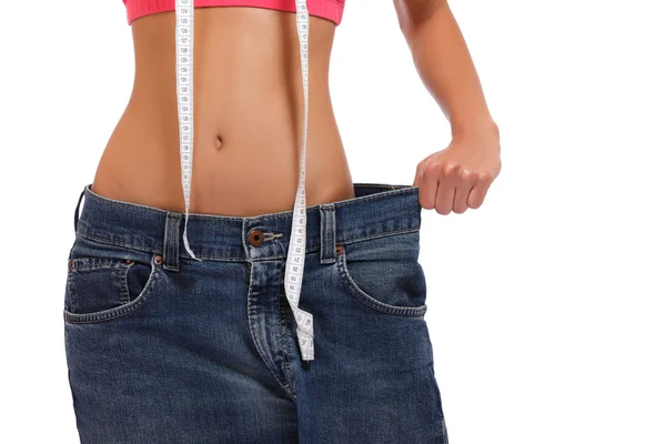 Perda de peso mulher mostrando perda de peso no branco — Fotografia de Stock