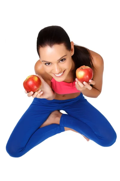 Brunette teeanger sitting on the floor with apples — Stock Photo, Image