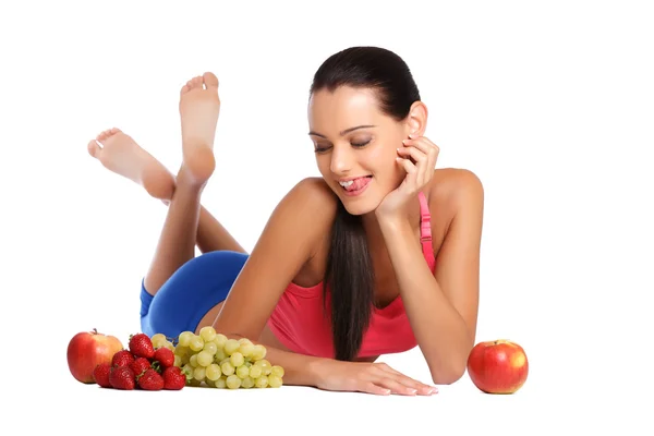Hungry brunette teenager with healthy fruits — Stock Photo, Image