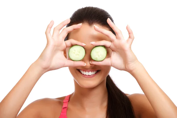 Funny portrait of a teenager holding slice of cucumber — Stock Photo, Image