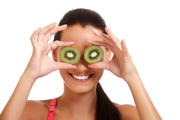 Funny portrait of a young brunette woman with kiwi — Stock Photo, Image