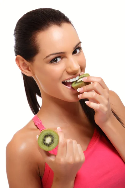 Brunette lady eating kiwi — Stock Photo, Image