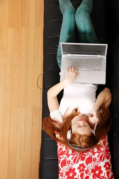 Young Redhead Girl surfing on the Sofa — Stock Photo, Image