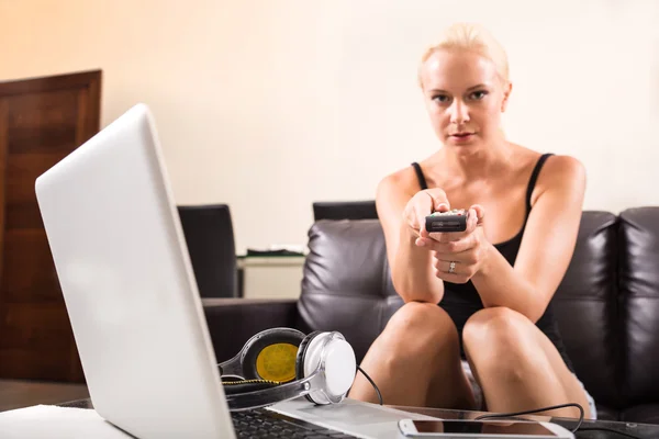 Blonde Girl with a remote control — Stock Photo, Image