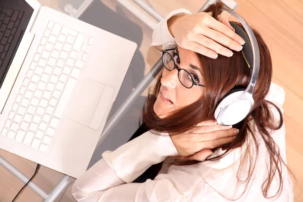 Woman with a Laptop and Headphones — Stock Photo, Image