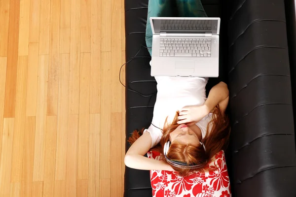 Young Redhead Girl surfing on the Sofa — Stock Photo, Image