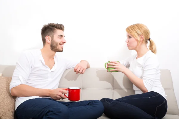 Young couple flirting on the Sofa — Stock Photo, Image