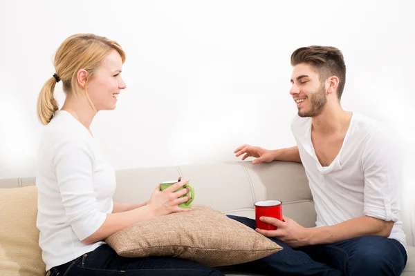 Young couple flirting on the Sofa — Stock Photo, Image