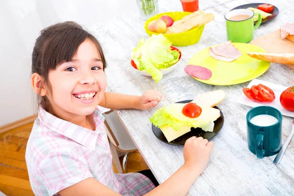 Little girl having breakfast at home — Stock Photo, Image