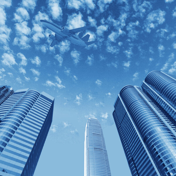 Hongkong's skyscrapers and airplanes on sky