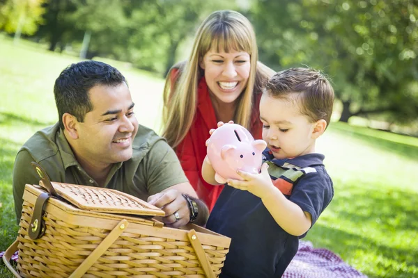 Mixed Race Couple Give Their Son a Piggy Bank at the Park — Stock Photo, Image