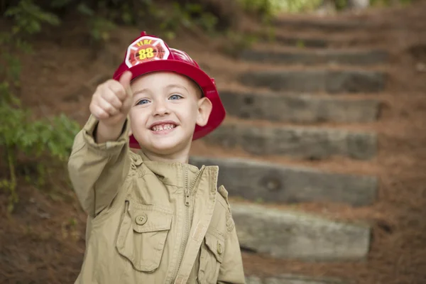 Adorabile bambino ragazzo con cappello da pompiere che gioca fuori — Foto Stock