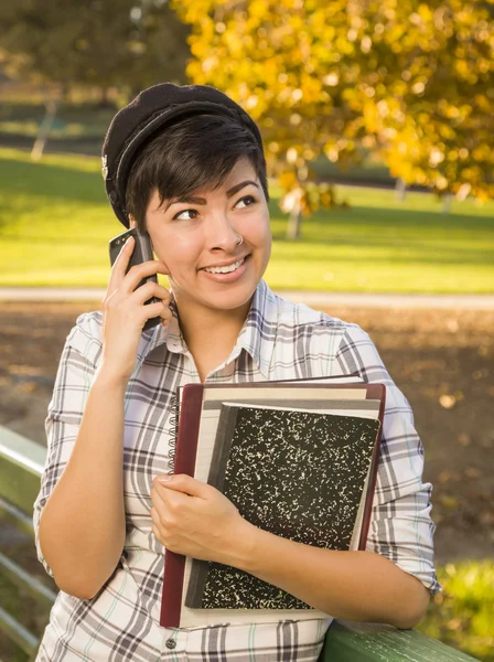 Mestiça Estudante Feminino Segurando Livros e Conversando por Telefone — Fotografia de Stock