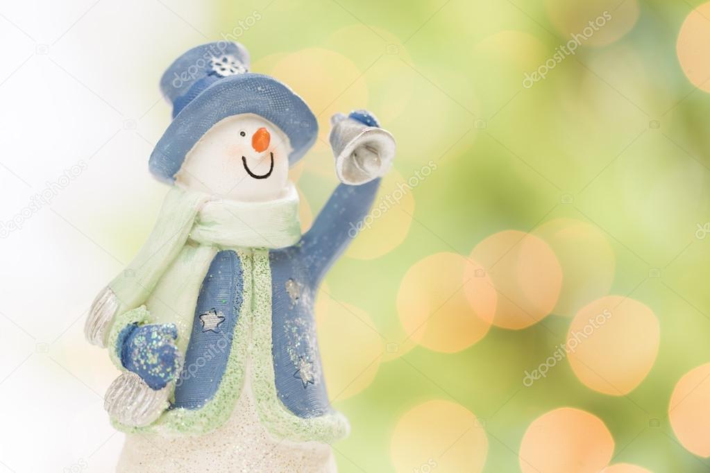 Snowman Statue On Snow Over a Blurry Abstract Background