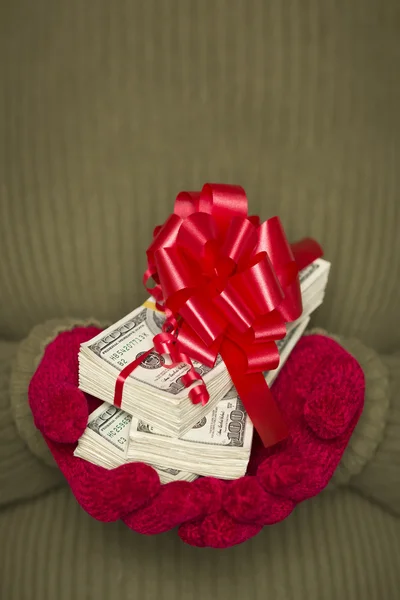 Woman Wearing Mittens Holding Stacks of Money with Red Ribbon — Stock Photo, Image