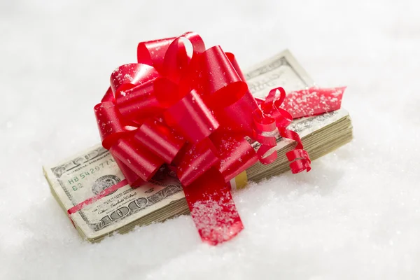 Stack of Hundred Dollar Bills with Red Ribbon on Snow — Stock Photo, Image