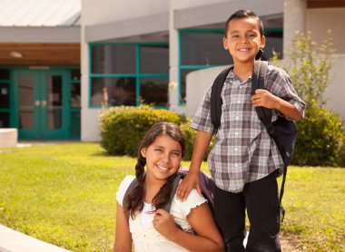 Cute Hispanic Brother and Sister Ready for School clipart