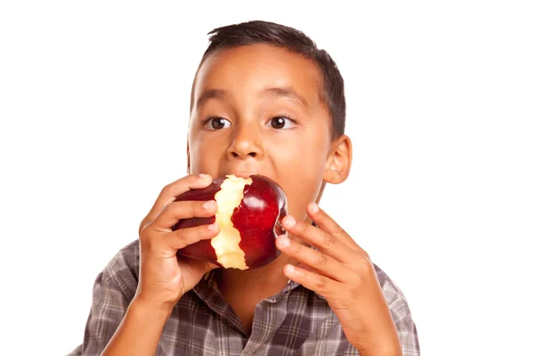 Adorable chico hispano comiendo una manzana roja grande —  Fotos de Stock