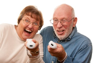 Happy Senior Couple Play Video Game with Remotes clipart