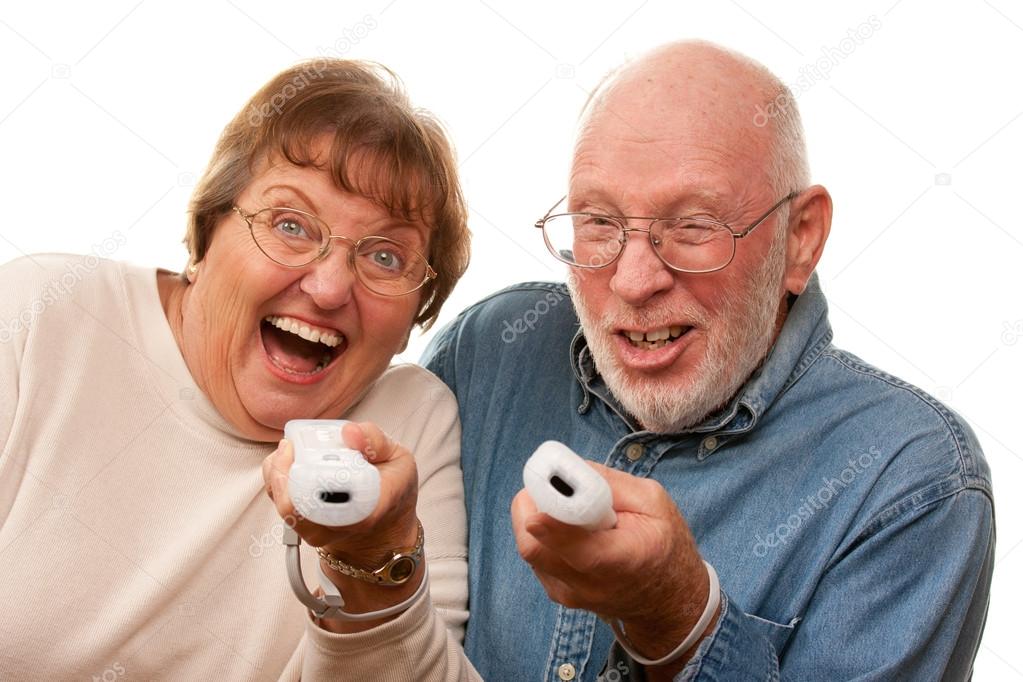 Happy Senior Couple Play Video Game with Remotes