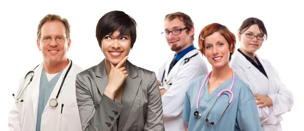 Young Mixed Race Woman with Doctors and Nurses Behind Stock Picture