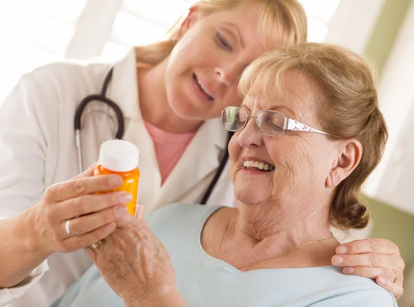 Female Doctor or Nurse Explaining Prescription to Senior Adult W — Stock Photo, Image