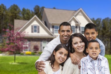Hispanic Family in Front of Beautiful House clipart