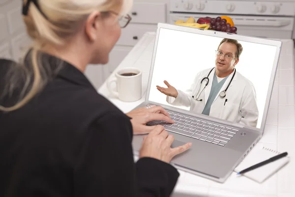 Mulher na cozinha usando laptop - Online com enfermeira ou médico — Fotografia de Stock