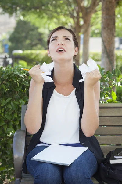 Naštvaná mladá žena s tužkou a zmačkaný papír v ruce — Stock fotografie