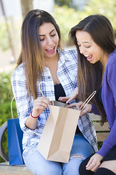 Jeunes femmes de race mixte adultes regardant dans leurs sacs à provisions — Photo