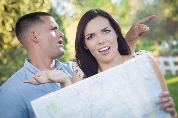 Lost and Confused Mixed Race Couple Looking Over Map Outside — Stock Photo, Image