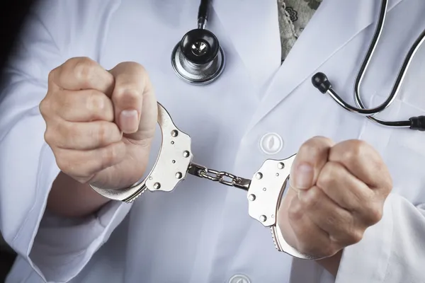 Doctor or Nurse In Handcuffs Wearing Lab Coat and Stethoscope — Stock Photo, Image