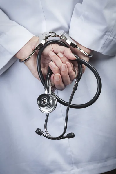 Female Doctor or Nurse In Handcuffs Holding Stethoscope — Stock Photo, Image