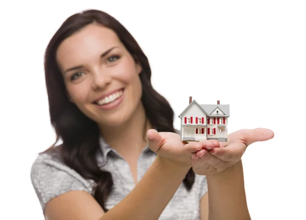 Feliz mulher de raça mista segurando pequena casa isolada em branco — Fotografia de Stock