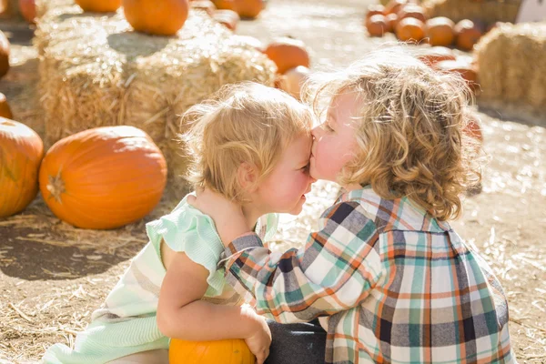 Sweet Little Boy Kisses His Baby Sister at Pumpkin Patc — Stock Photo, Image
