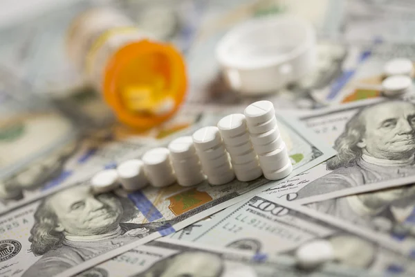 Medicine Pills Stacked on Newly Designed One Hundred Dollar Bill — Stock Photo, Image