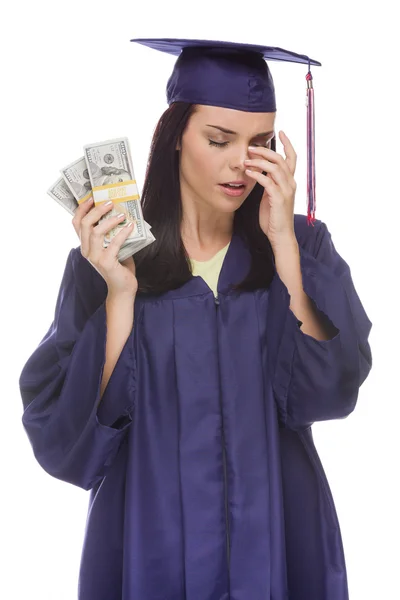 Mujer estresada graduada sosteniendo pilas de billetes de cien dólares — Foto de Stock