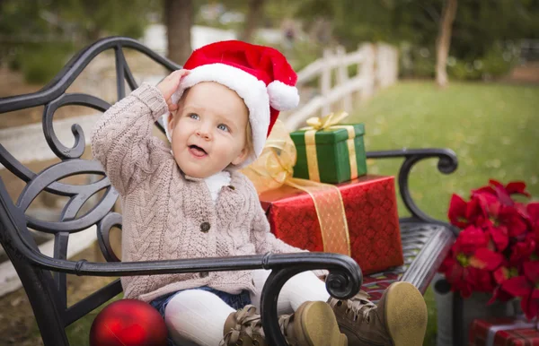 Niño pequeño con sombrero de Santa sentado con regalos de Navidad Outsi — Foto de Stock