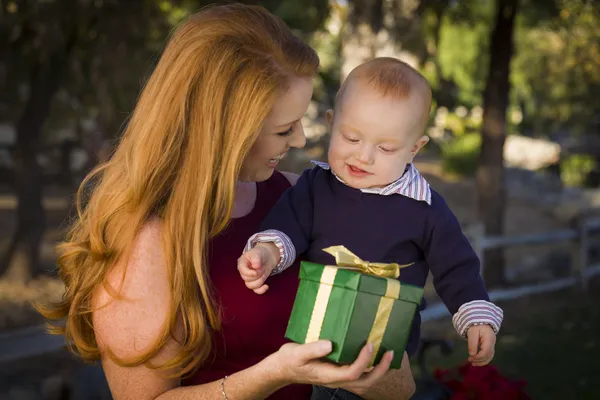 Bela jovem mãe e bebê com presente de Natal — Fotografia de Stock