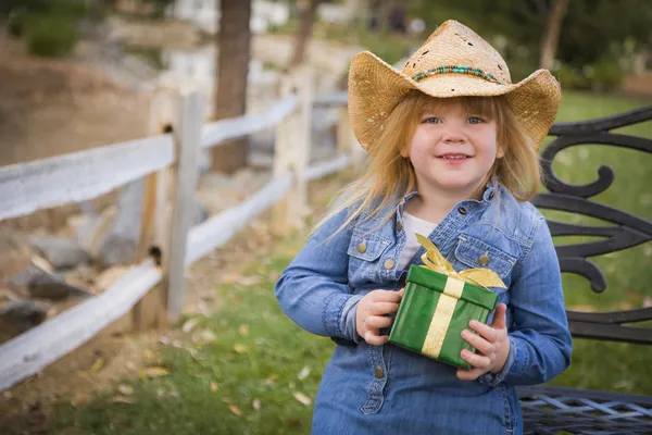 Young Girl Wearing Holiday Clothing Holding Christmas Gift Outsi — Stock Photo, Image