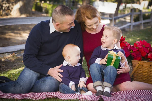 Small Young Family Opening Christmas Gifts in the Park — Stock Photo, Image